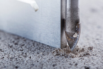 Ceramic drill bit make holes in concrete wall with industrial drill. Building work industry.