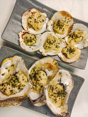 Scallop and oyster dish with melted cheese