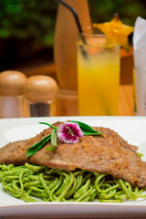Green sauce pesto spaghetti with breaded beef filet gourmet restaurant food