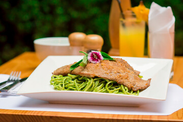Green sauce pesto spaghetti with breaded beef filet gourmet restaurant food