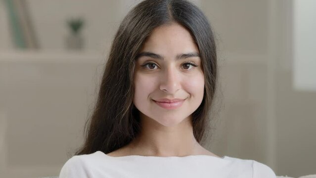 Portrait of beautiful seductive 20s sexy lady woman attractive appearance arabian hispanic gorgeous girl teen looking at camera happy stylish millennial model with natural makeup gloss health skincare