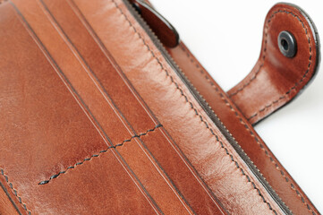 Black stitches on brown leather wallet