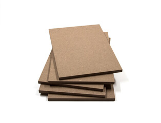 Boards of raw mdf irregularly arranged in a pile.