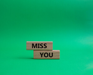 Miss you. Concept word Miss you on wooden cubes. Beautiful green background. Business and Miss you concept. Copy space.