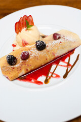 Crepe pancakes with strawberries and ice cream