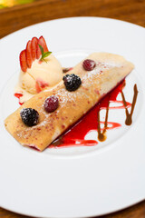Crepe pancakes with strawberries and ice cream