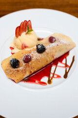 Crepe pancakes with strawberries and ice cream