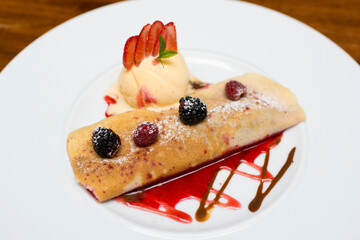 Crepe pancakes with strawberries and ice cream