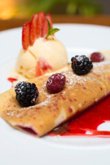Crepe pancakes with strawberries and ice cream