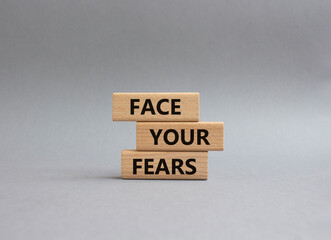 Face your Fears symbol. Wooden blocks with words Face your Fears. Beautiful grey background. Business and Face your Fears. Copy space.