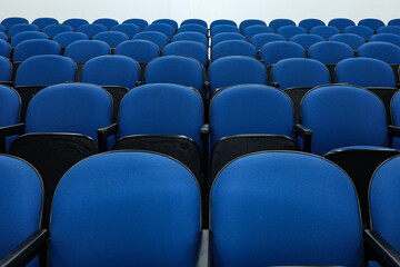 Obraz premium Rows of several blue chairs in an auditorium, or theater, with no person and all seats the same.