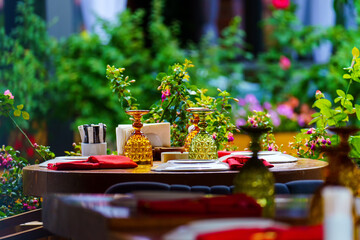Bocklas and plates are turned over on the table of an outdoor restaurant so that dust does not get on them