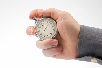 hand with a mechanical analog stopwatch on a white background. Time part precision. Measurement of the speed interval