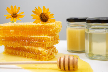 Fresh flower honey in combs and a wooden spoon. vitamin food for health and life