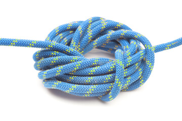 durable colored rope for climbing equipment on a white background. knot of braided cable. item for tourism and travel