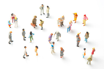 miniature people. different people stand on a white background. communication of society of...