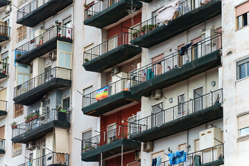 Italian apartment building with balconies and windows.