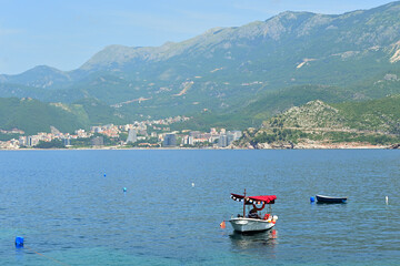 Fototapeta na wymiar Boat moored in Sveti Stefan Bay, Montenegro