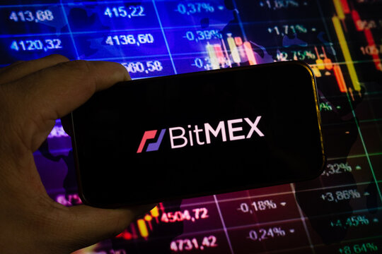 KONSKIE, POLAND - August 10, 2022: Smartphone displaying logo of BitMEX cryptocurrency exchange on stock exchange chart background