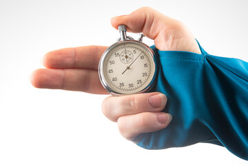 hand with finger direction pointer and mechanical stopwatch on white background. Time part...