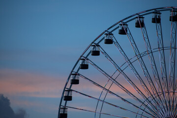 High ferris wheel in a cloudy summer sunset