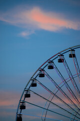 High ferris wheel in a cloudy summer sunset