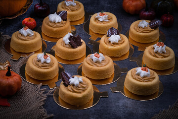 Cake shells filled with pumpkin spice cream, decorated  with chocolate leaves and little royal icing pumpkins