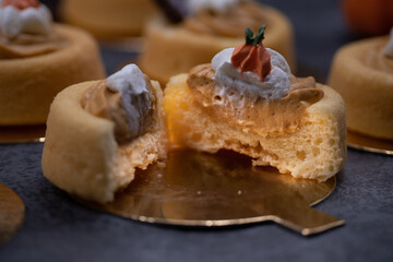 Cake shells filled with pumpkin spice cream, decorated  with chocolate leaves and little royal icing pumpkins