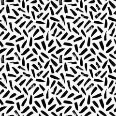 Seamless pattern with irregular black dashes. Simple geometric texture with short brushstrokes. Abstract background in Memphis style. Ink painted hand made texture. Vector black ink ornament.