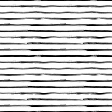 Seamless pattern with handdrawn thin lines. Hand painted grungy ink doodles in black and white colors. Horizontal simple stripes, texture brush strokes. Classic black and white stripes pattern.