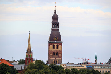 Fototapeta premium View of the tower of Riga Dom church. Dom church tower with a clock