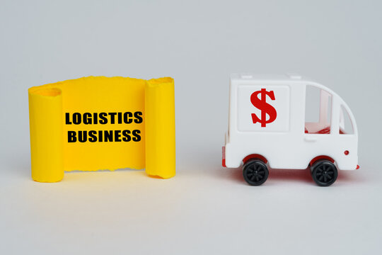 On a white surface, a typewriter and a yellow paper plate with the inscription - logistics business