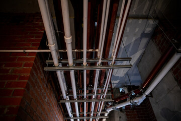 Electrical conduit system and galvanized steel pipe of electric cable installed on ceiling. PVC...