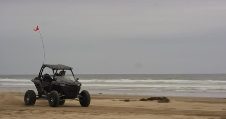 ATV riding along beach at Oceano Dunes SVRA at Pismo Beach, California