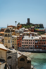 Aerial view of Vernazza and coastline of Cinque Terre,Italy.UNESCO Heritage Site.Picturesque colorful village on rock above sea.Summer holiday,travel background.Italian Riviera landscape.Steep cliff.