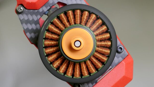 Close up of brushless motor spinning on multicopter arm. The inner coils are made up of wound copper wire. These coils are fixed in place. The outer shell with the magnets turns around the coils
