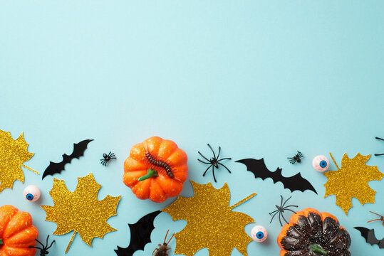 Halloween decorations concept. Top view photo of pumpkins gold sparkle maple leaves bat silhouettes eyes spiders cockroach and centipede on isolated pastel blue background with copyspace