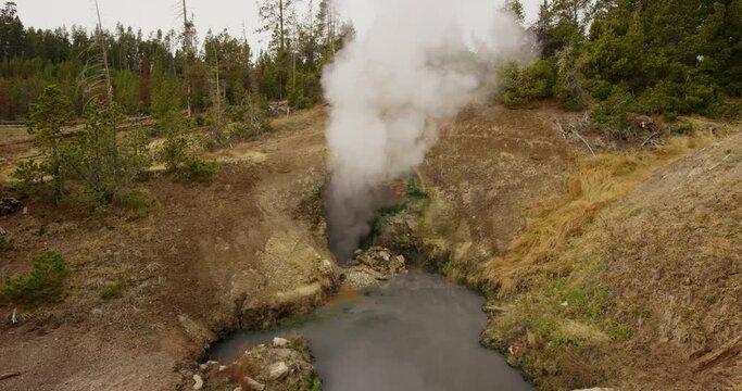 A bubbling mud volcano called Dragon's Mouth Spring in Yellowstone National Park