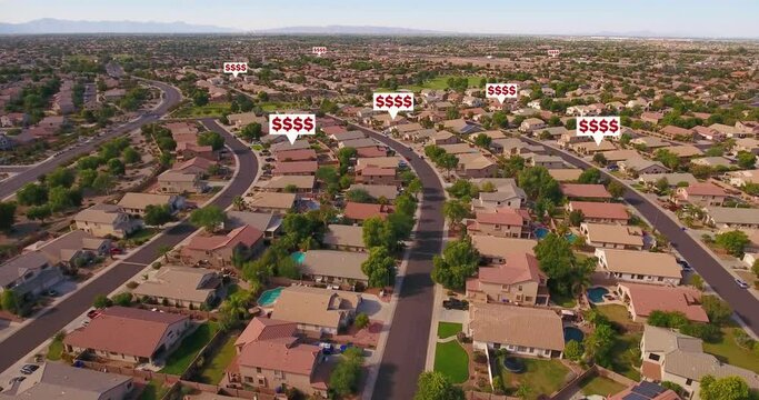 An aerial establishing shot of a typical Arizona residential neighborhood with price tag over random homes that represents the rising cost of rental and real estate properties. Phoenix suburbs.  	
