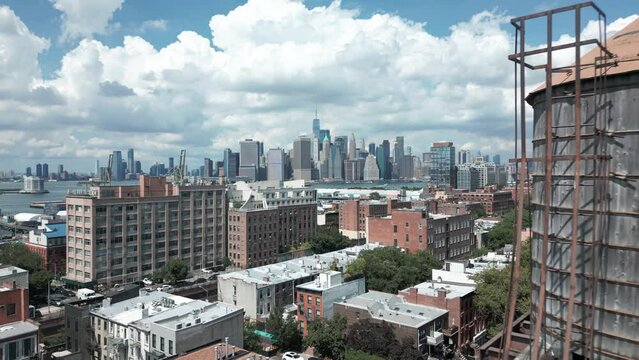 alt view of downtown NYC skyline flying backwards revealing rooftop watertank