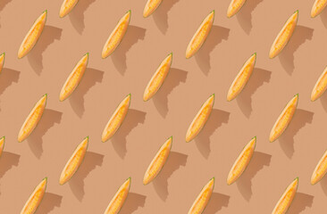 Pattern of cut cantaloupe melon on orange pastel background