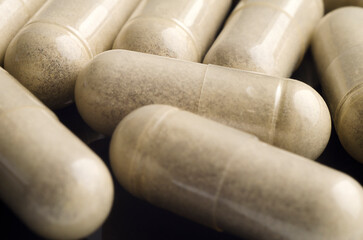 Medical capsules are on the table. Close