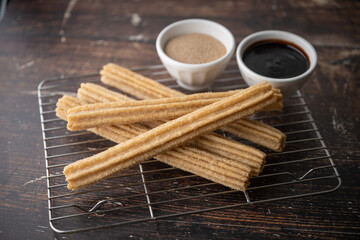 churros with chocolate sauce and cinnamon powder