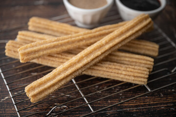churros with chocolate sauce and cinnamon powder