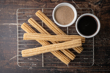 churros with chocolate sauce and cinnamon powder