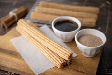 churros with chocolate sauce and cinnamon powder