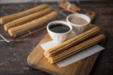 churros with chocolate sauce and cinnamon powder