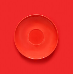 Red plates on red table. Monochrome minimalistic image in hipster style.