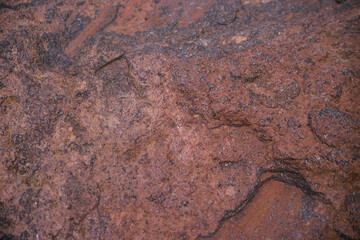 Stone brown textured background. Natural stone. Uneven surface. The surface is covered with rust.