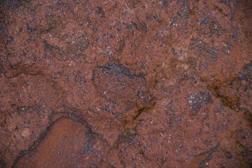 Stone brown textured background. Natural stone. Uneven surface. The surface is covered with rust.